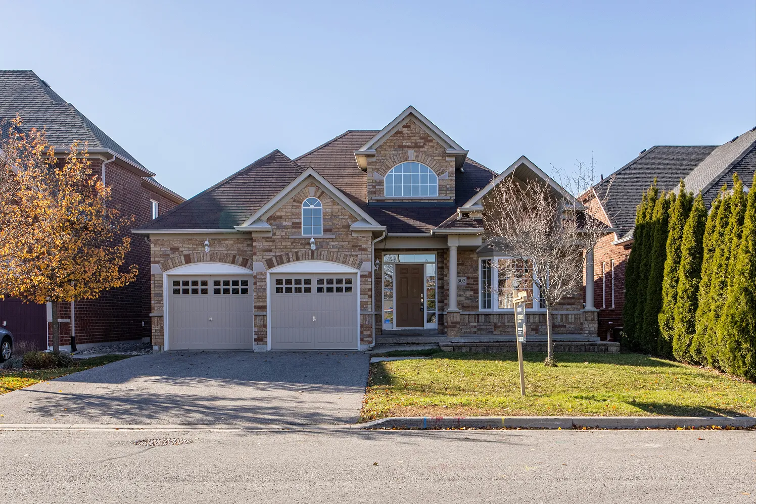 Brick house with a two-car garage, original photo