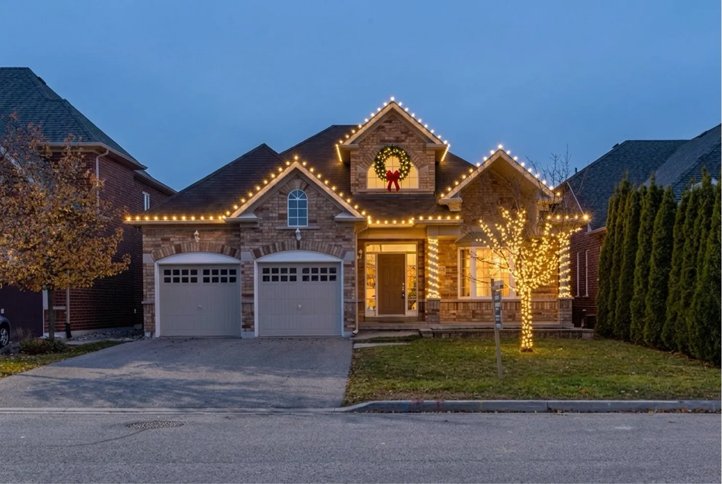Brick house with a two-car garage, AI render with holiday lights
